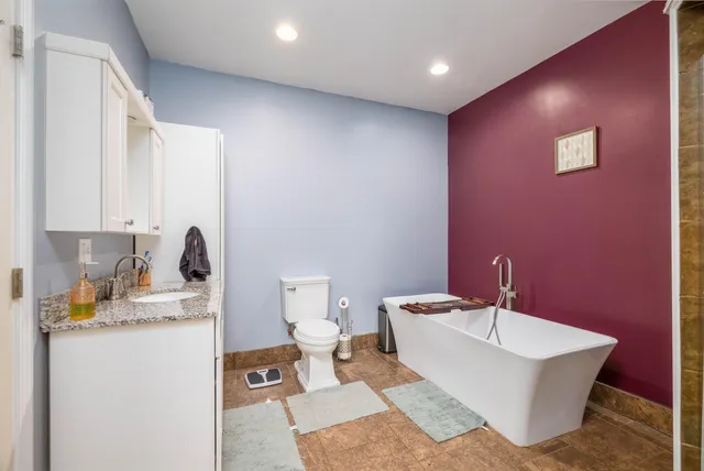 a bathroom with a sink a toilet and mirror