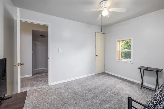 a view of an empty room with a window
