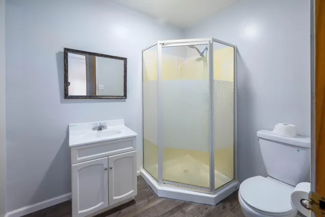 a bathroom with a toilet a sink and shower