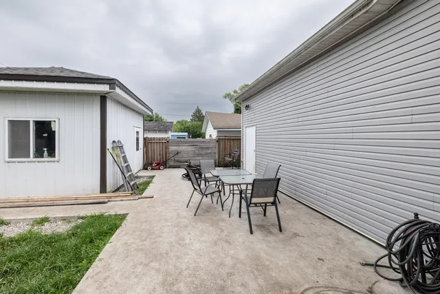 a view of a patio with table and chairs and potted plants