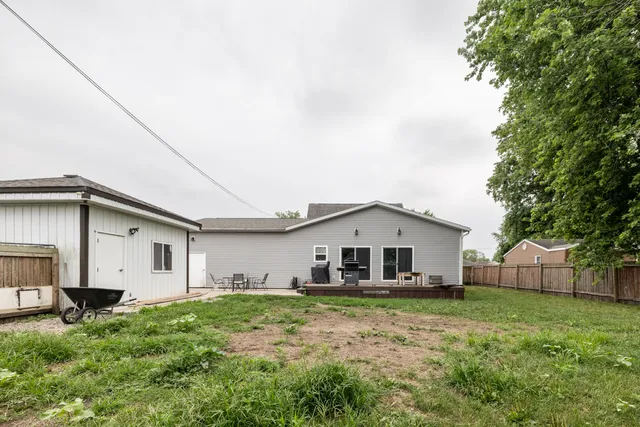 a view of house with backyard
