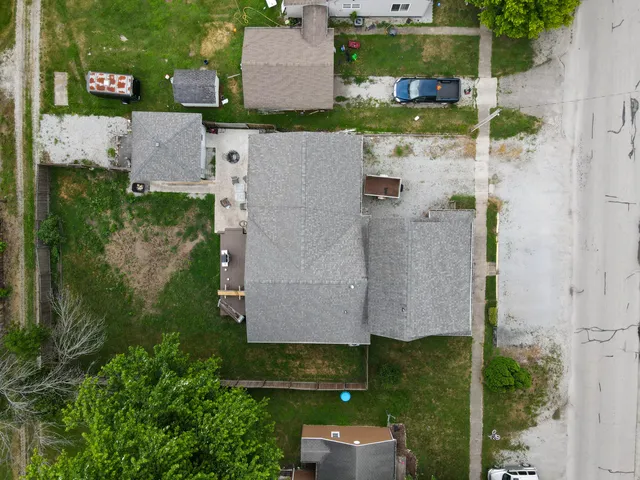 an aerial view of a house with a yard