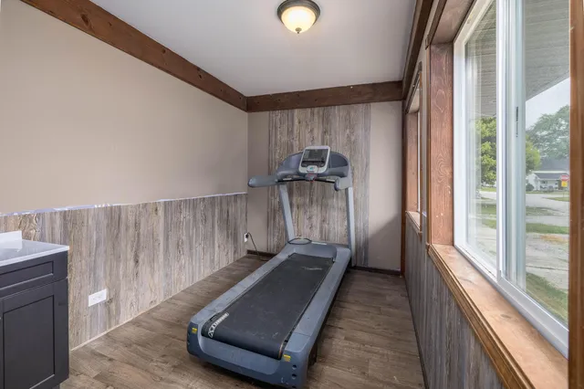 a view of a room with wooden floor and windows