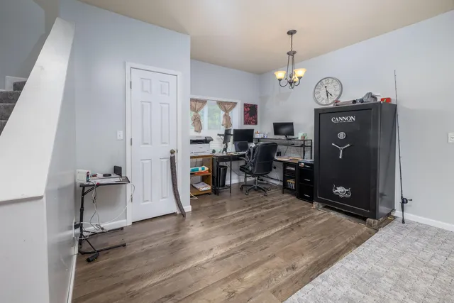 a view of a workspace with furniture and chandelier
