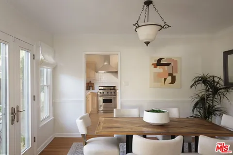 a view of a dining room with furniture wooden floor and a chandelier