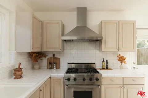 a kitchen with a stove and cabinets