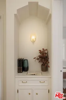 a view of a hallway with wooden floor and furniture