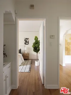 a bedroom with a large bed and a potted plant