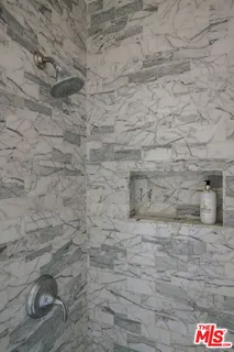 a bedroom with a bed and cabinets