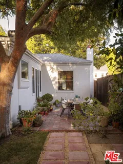 a view of a house with patio and wooden floor