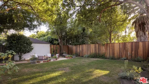 a view of garden with wooden fences
