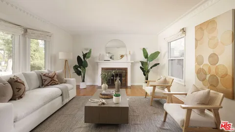 a living room with furniture white walls and a fireplace