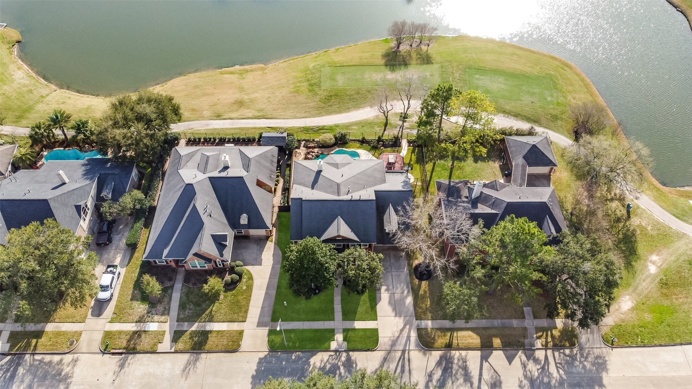 24403 Falcon Point Drive Katy, TX 77494 - Photo 2 of 32 Spectacular aerial view showcasing the home's premier location on a sprawling lot, bordered by the serene lake.