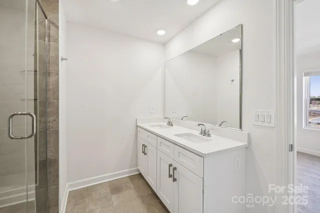 a bathroom with a double vanity sink a and a mirror