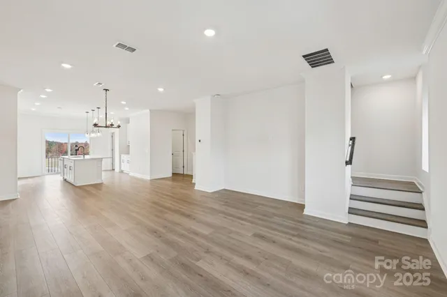 a view of a kitchen with wooden floor and a kitchen