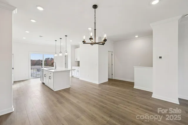 a view of a kitchen with wooden floor and a kitchen