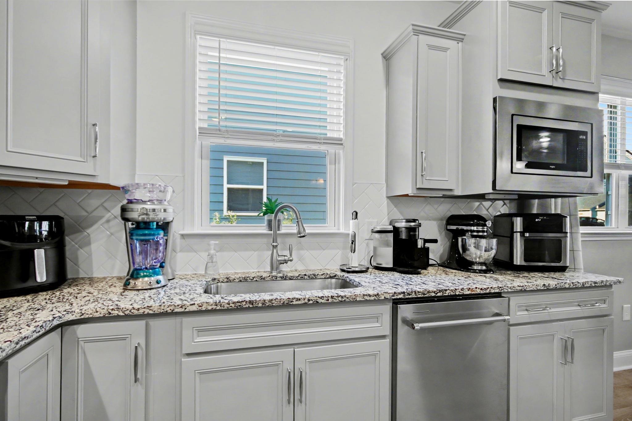 5830 Cremona Drive Myrtle Beach, SC 29577 - Photo 13 of 39 Kitchen featuring light stone countertops, appliances with stainless steel finishes, and decorative backsplash
