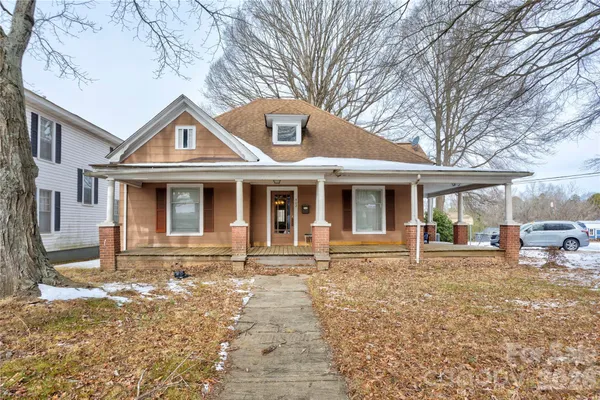 a front view of a house with yard outdoor seating and barbeque oven