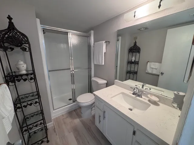 a bathroom with a sink toilet and shower