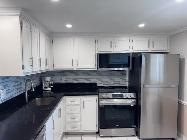 a kitchen with a stove and a refrigerator