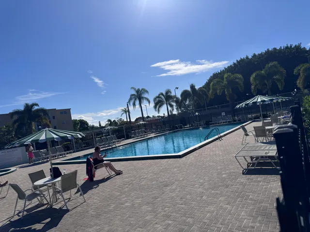 a view of a swimming pool with outdoor seating and a terrace