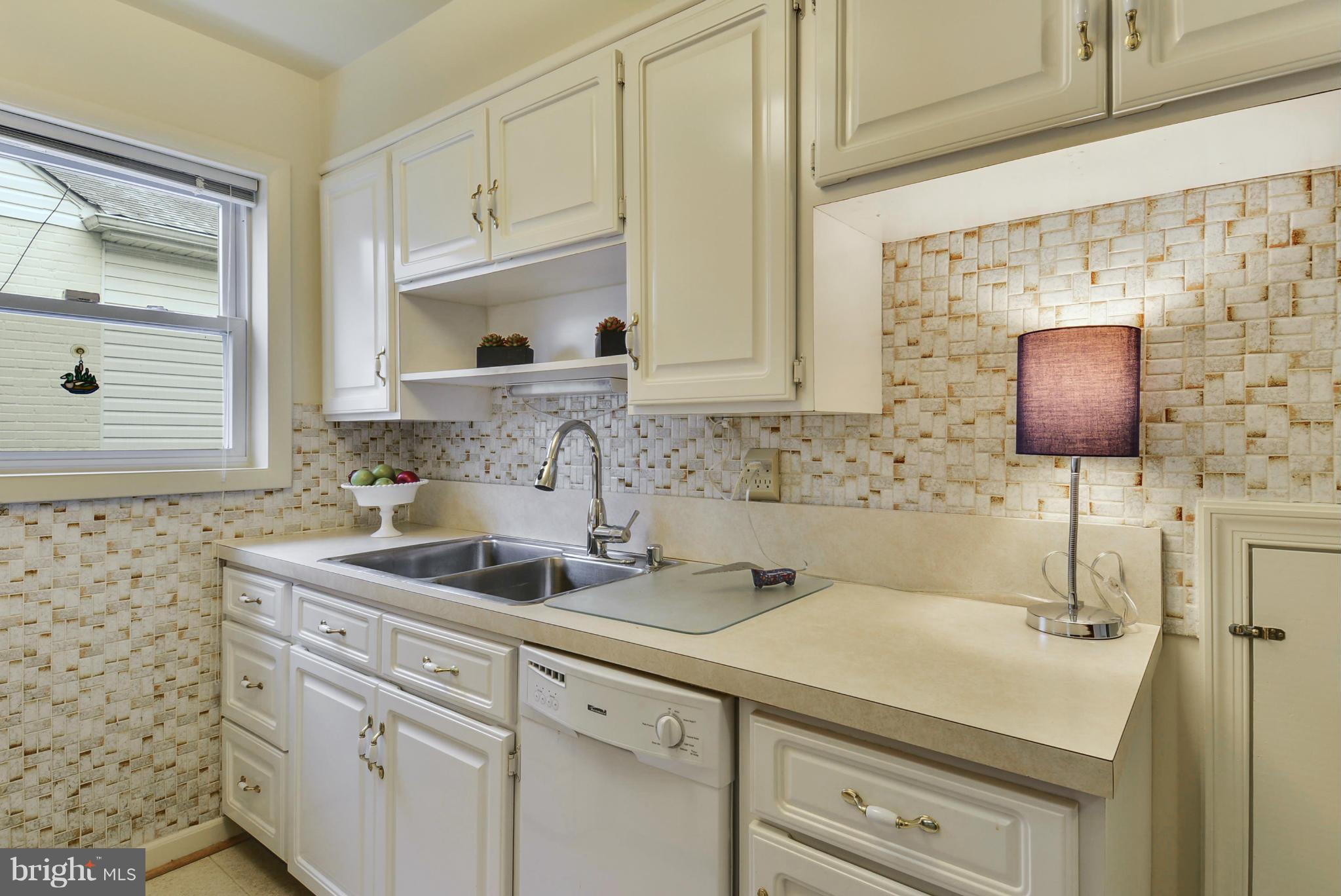 12613 Epping Road Silver Spring, MD 20906 - Photo 14 of 29 a kitchen with a sink cabinets and window