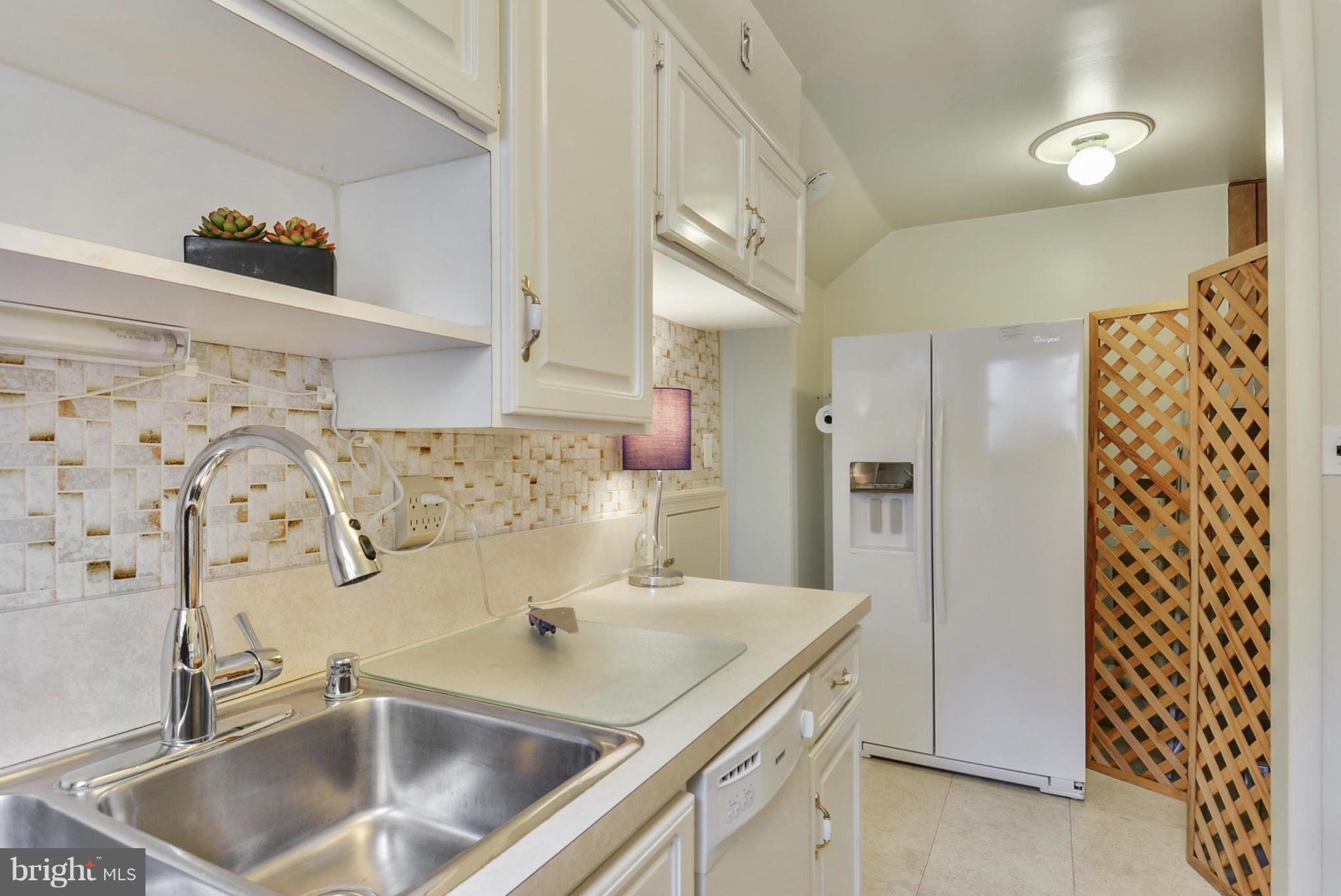 12613 Epping Road Silver Spring, MD 20906 - Photo 16 of 29 a kitchen with a sink and a refrigerator