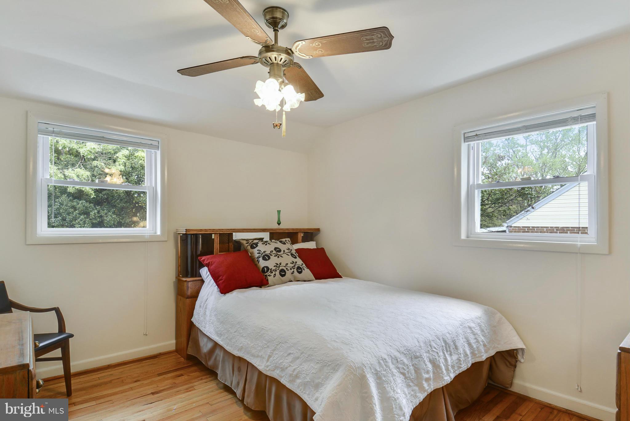 12613 Epping Road Silver Spring, MD 20906 - Photo 17 of 29 a bedroom with a bed and a chandelier