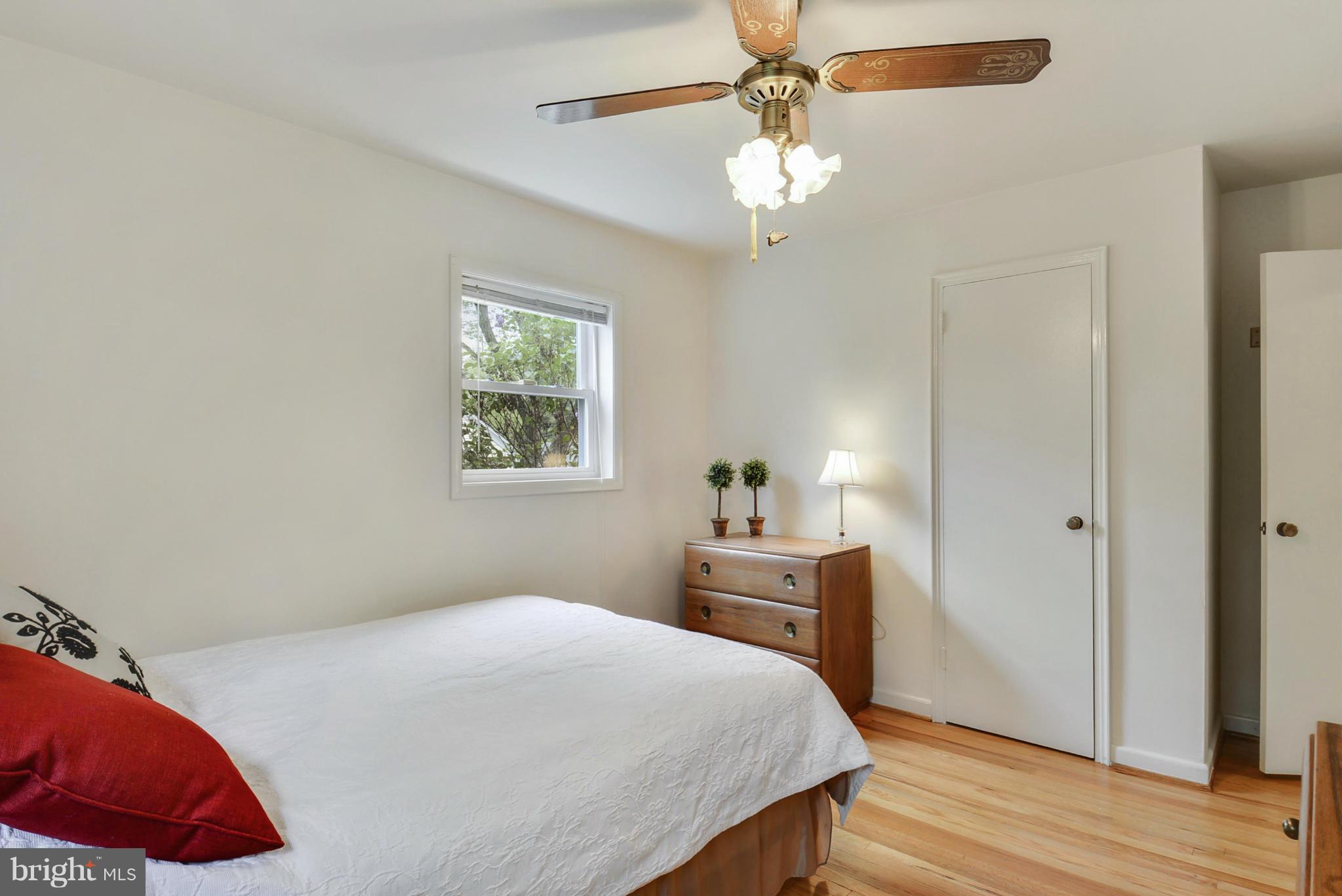12613 Epping Road Silver Spring, MD 20906 - Photo 18 of 29 a bedroom with a bed and a chandelier
