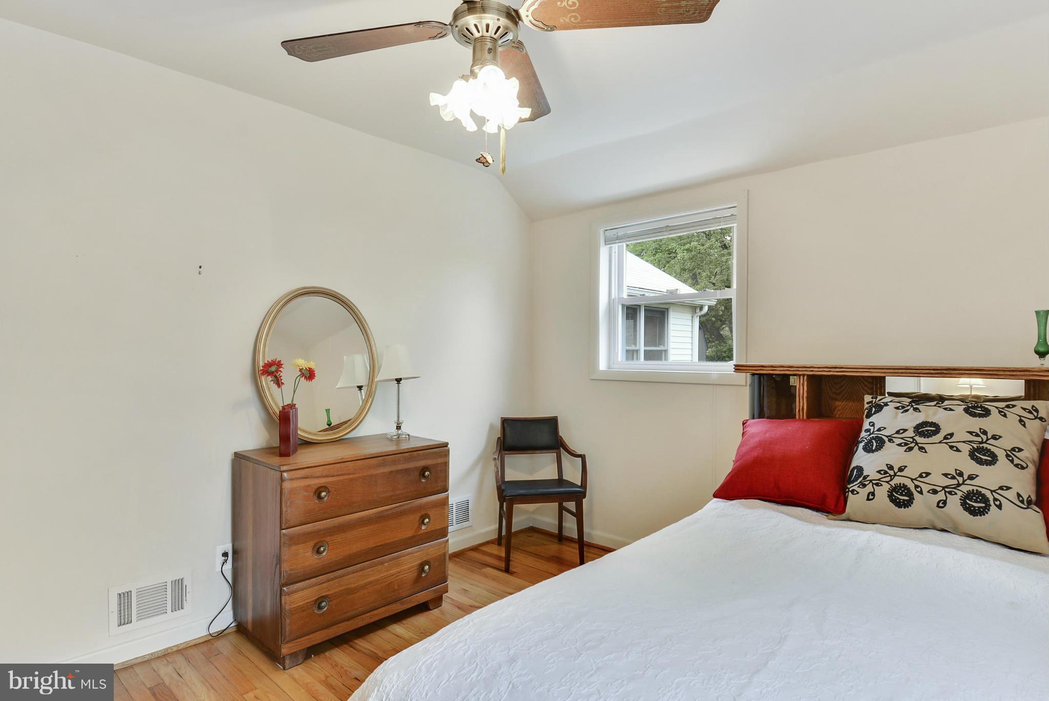 12613 Epping Road Silver Spring, MD 20906 - Photo 19 of 29 a bedroom with bed and a chandelier