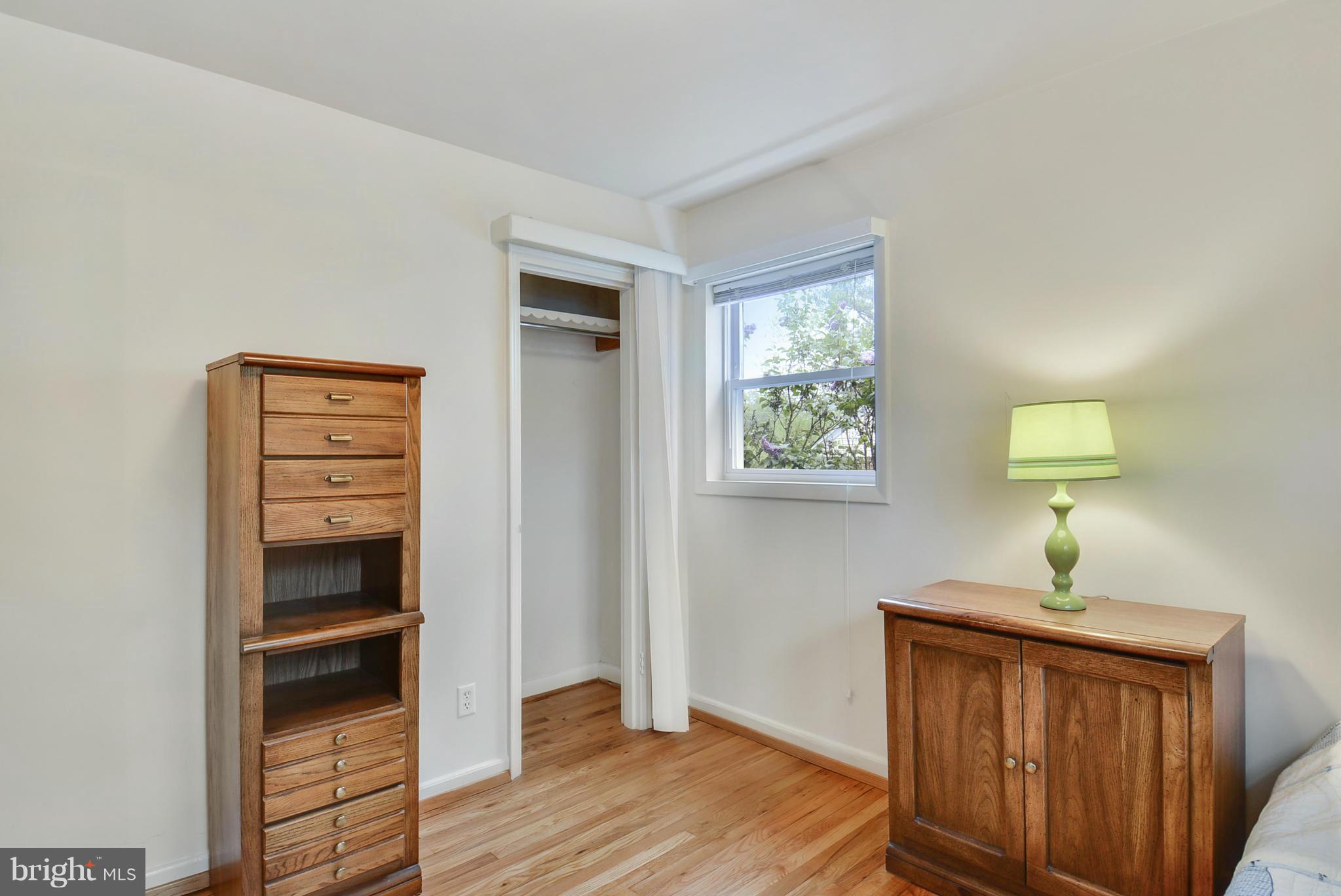12613 Epping Road Silver Spring, MD 20906 - Photo 21 of 29 a view of a hallway to room with wooden floor cabinet and stairs