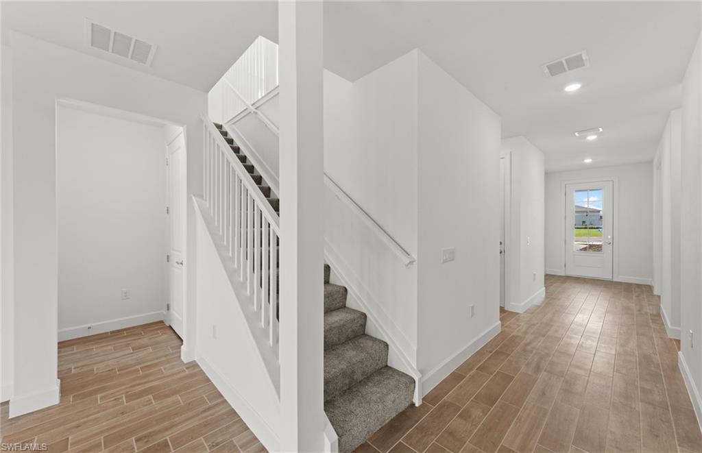 15629 Northridge Road Punta Gorda, FL 33982 - Photo 11 of 26 a view of a hallway with wooden floor and entryway