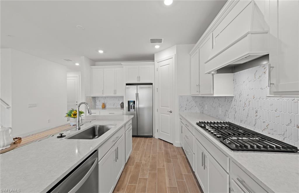 15629 Northridge Road Punta Gorda, FL 33982 - Photo 5 of 26 a kitchen with kitchen island sink stove and cabinets