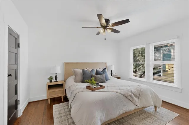 a bedroom with a bed and wooden floor