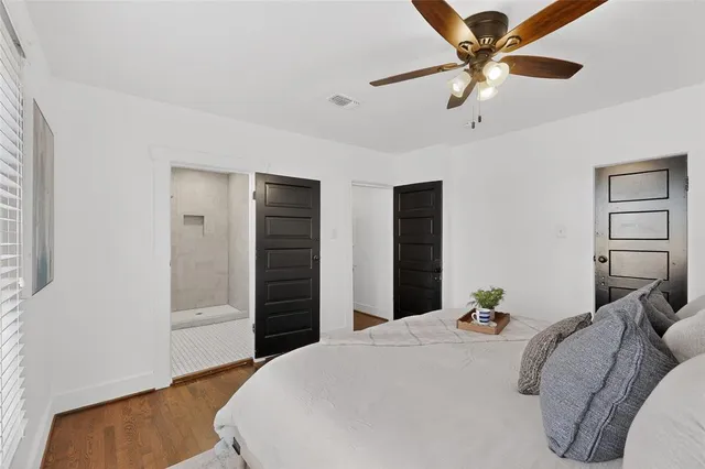 a bedroom with bed and wooden floor
