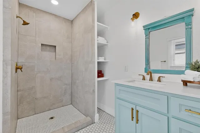 a bathroom with a shower sink and mirror