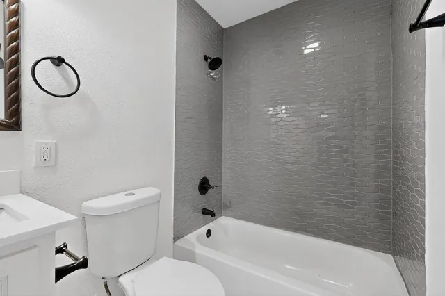 a bathroom with a toilet sink and shower