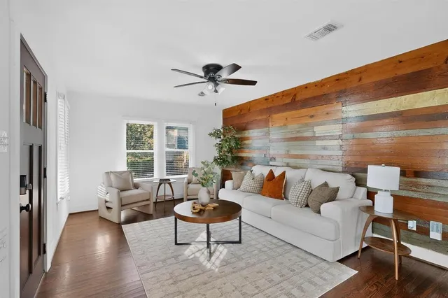 a living room with furniture and wooden floor