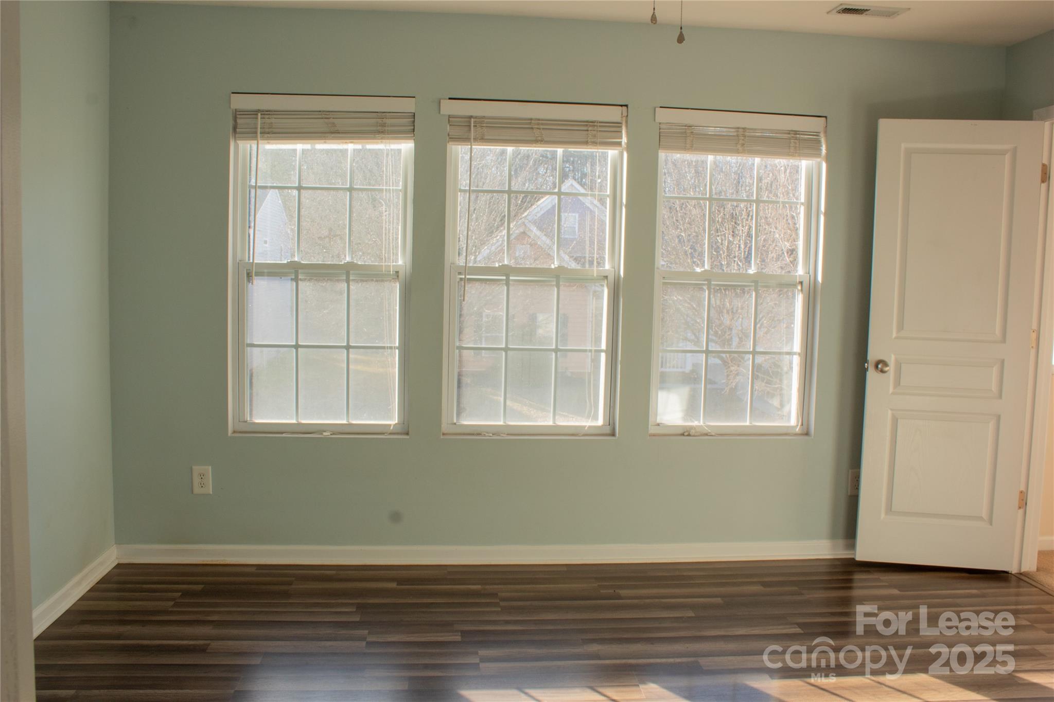 2049 Twilight Lane Monroe, NC 28110 - Photo 17 of 17 a view of an empty room with wooden floor and a window