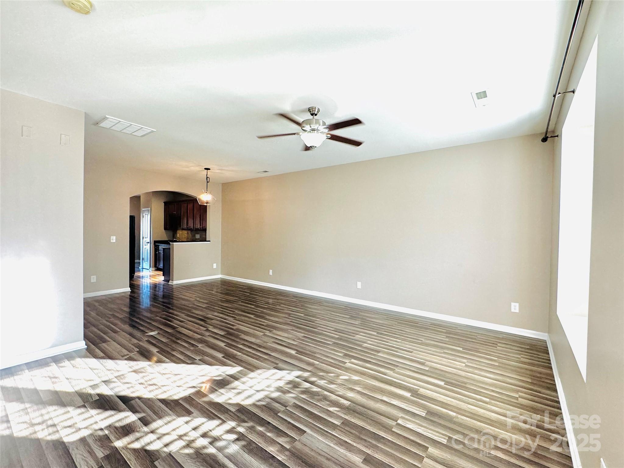 2049 Twilight Lane Monroe, NC 28110 - Photo 3 of 17 a view of a room with wooden floor and a ceiling fan
