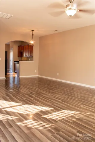 a view of a room with wooden floor