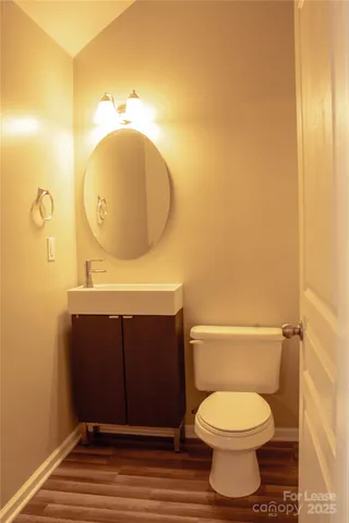 a bathroom with a toilet and a mirror