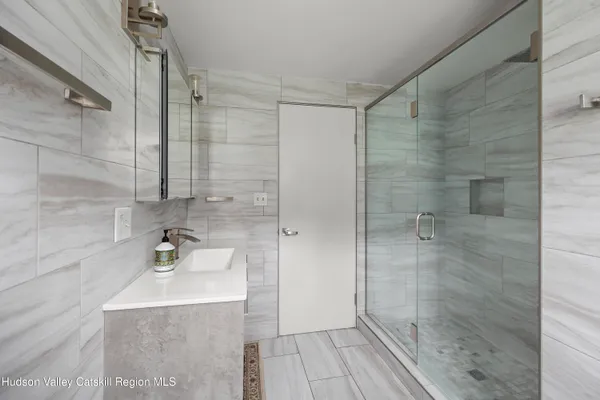 a bathroom with a sink a toilet and shower