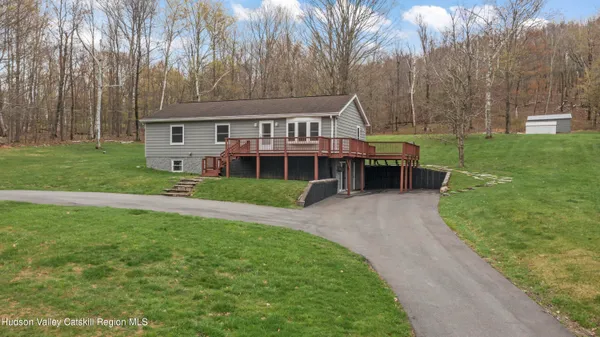 a view of a house with a yard and sitting area