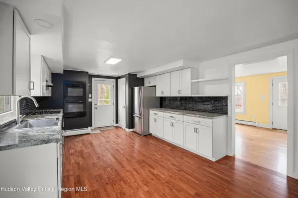 a kitchen with stainless steel appliances granite countertop a stove and a refrigerator