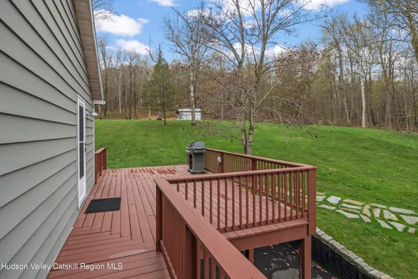 a view of balcony with wooden deck and garden