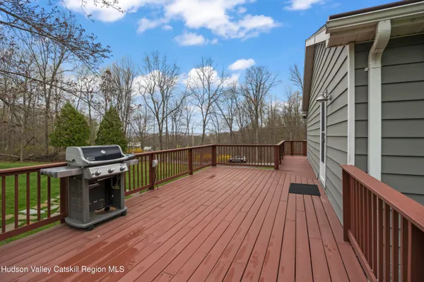 a view of a balcony with wooden floor and fence