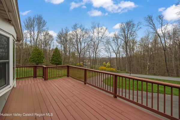 a view of balcony with wooden floor and fence