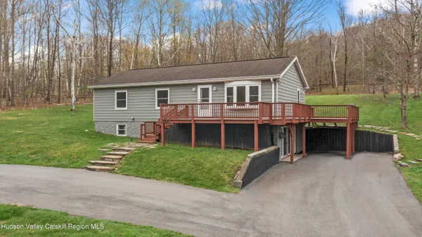a view of a house with a yard and sitting area