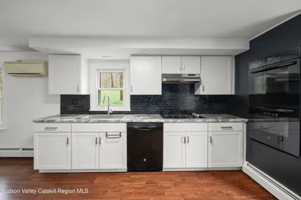 a kitchen with a sink stove and microwave
